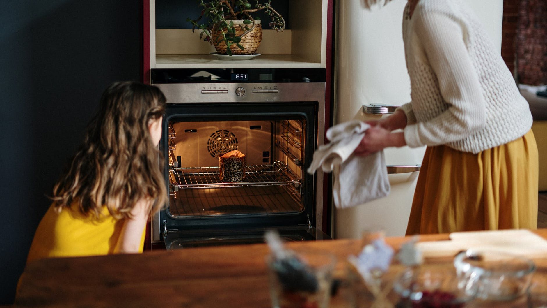 mom and daughter baking a cake
