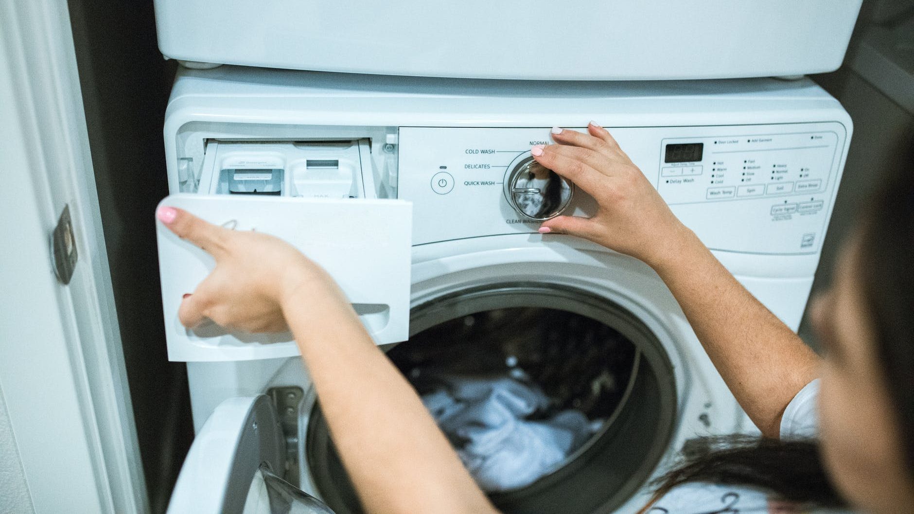 person holding white front load washing machine